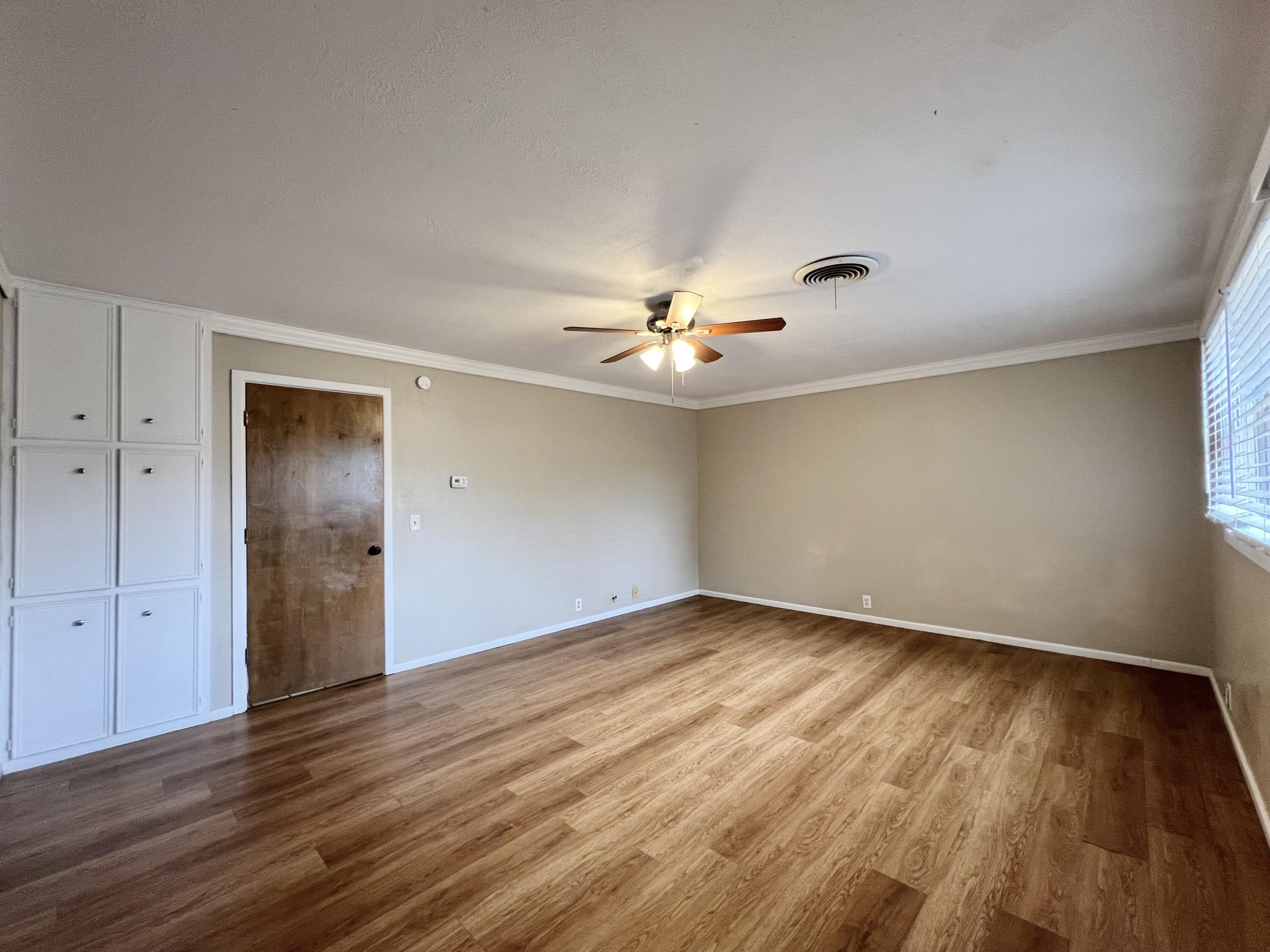 5113 13th Street, Unit A Lubbock, TX 79416 - Photo 4 of 25 a view of an empty room with wooden floor