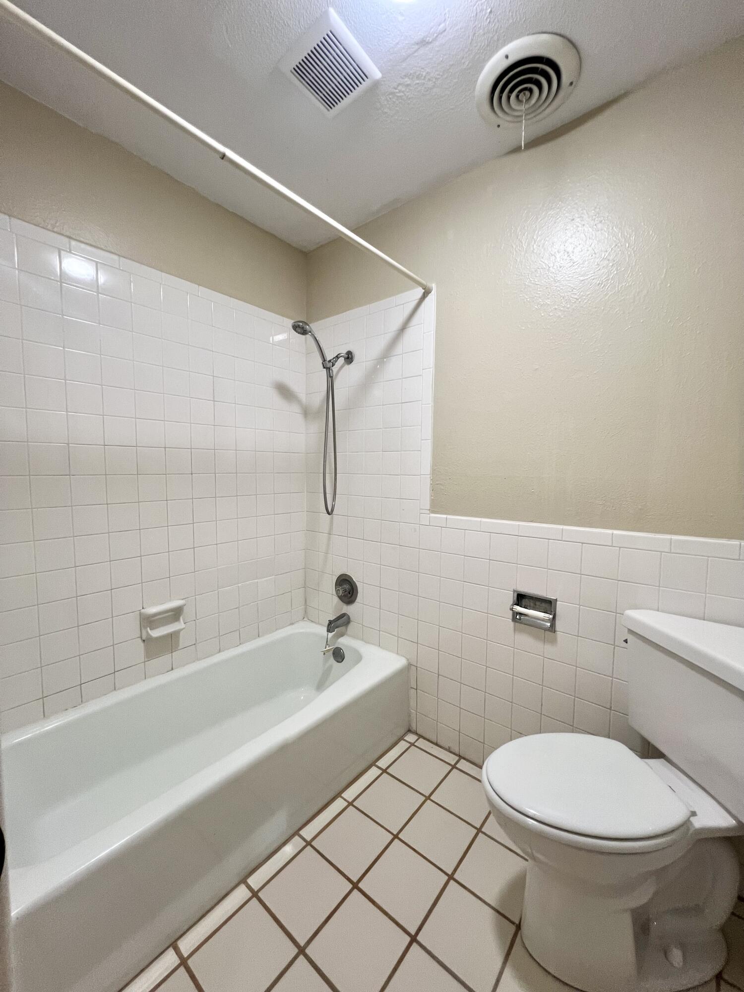 5113 13th Street, Unit A Lubbock, TX 79416 - Photo 6 of 25 a bathroom with a toilet and a bathtub