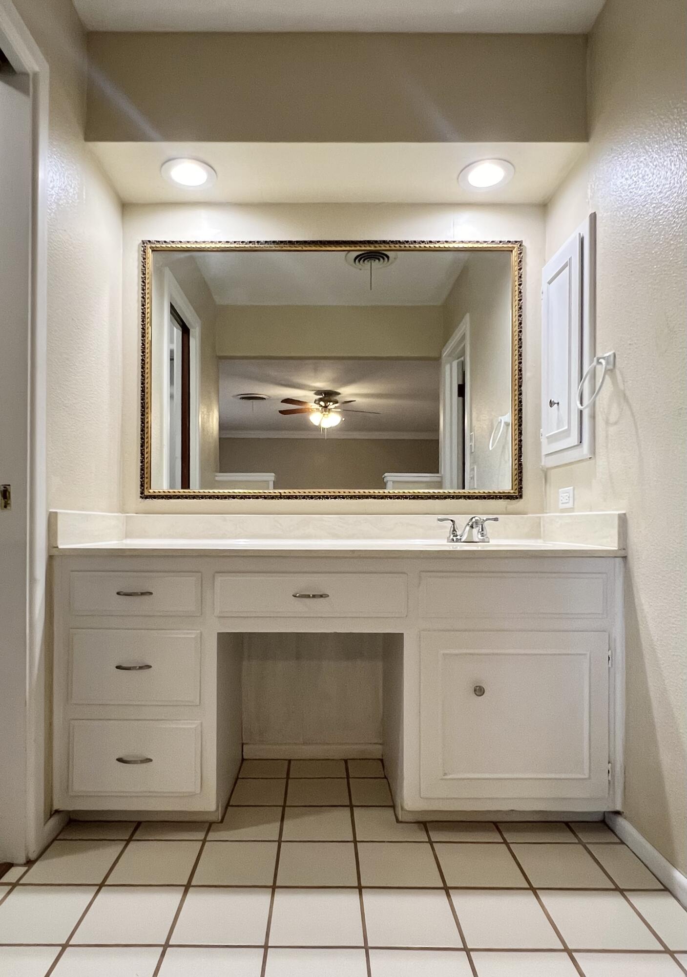 5113 13th Street, Unit A Lubbock, TX 79416 - Photo 7 of 25 a bathroom with a sink and a mirror