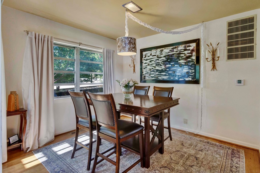 207 East Walnut Street Fredericksburg, TX 78624 - Photo 13 of 42 a view of a dining room with furniture window and wooden floor