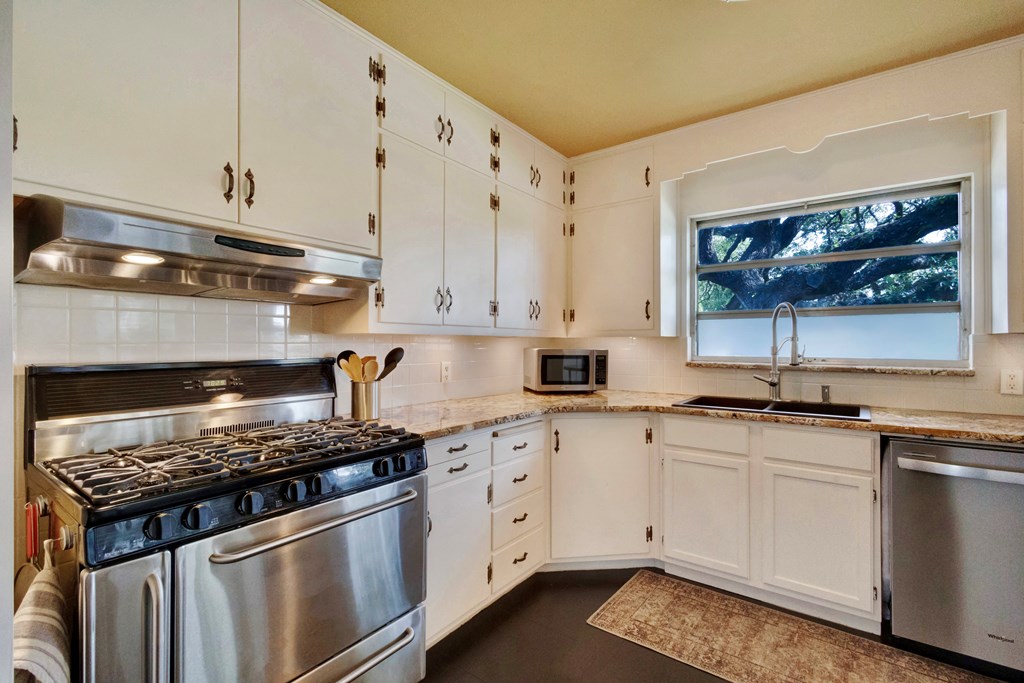 207 East Walnut Street Fredericksburg, TX 78624 - Photo 18 of 42 a kitchen with white cabinets and appliances