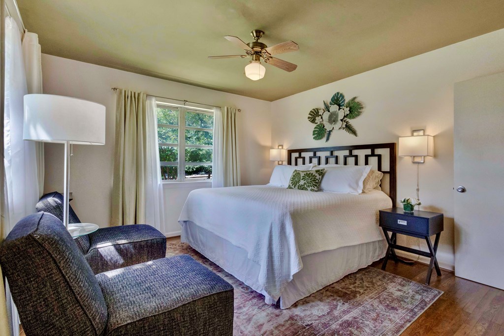 207 East Walnut Street Fredericksburg, TX 78624 - Photo 25 of 42 a bedroom with a bed and wooden floor