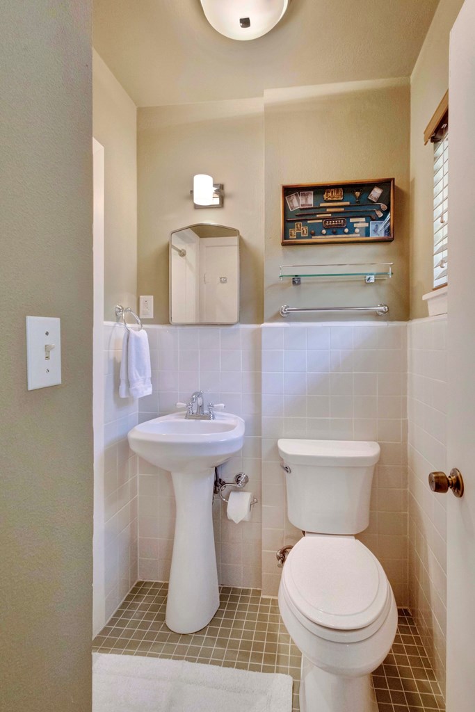 207 East Walnut Street Fredericksburg, TX 78624 - Photo 29 of 42 a bathroom with a toilet sink and mirror
