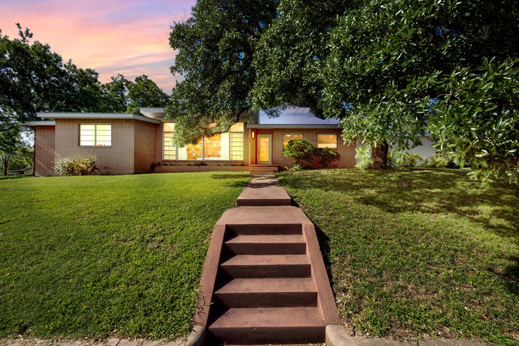 207 East Walnut Street Fredericksburg, TX 78624 - Photo 33 of 42 a front view of a house with a yard