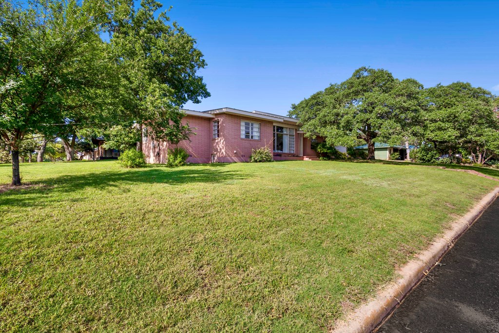 207 East Walnut Street Fredericksburg, TX 78624 - Photo 36 of 42 a view of a big yard with a house in the background