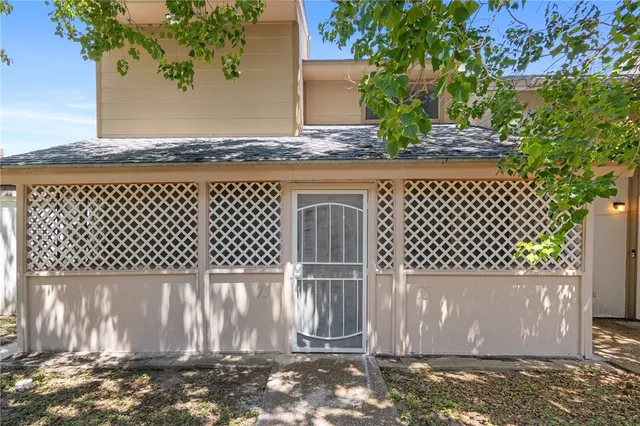 a view of a house with a tree in the background
