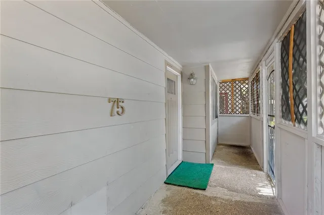 a view of a room that has a refrigerator and a table in it