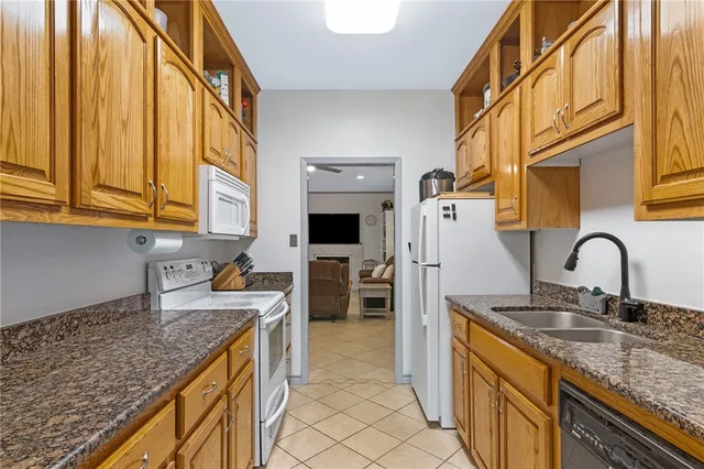 a living room with furniture and a book shelf