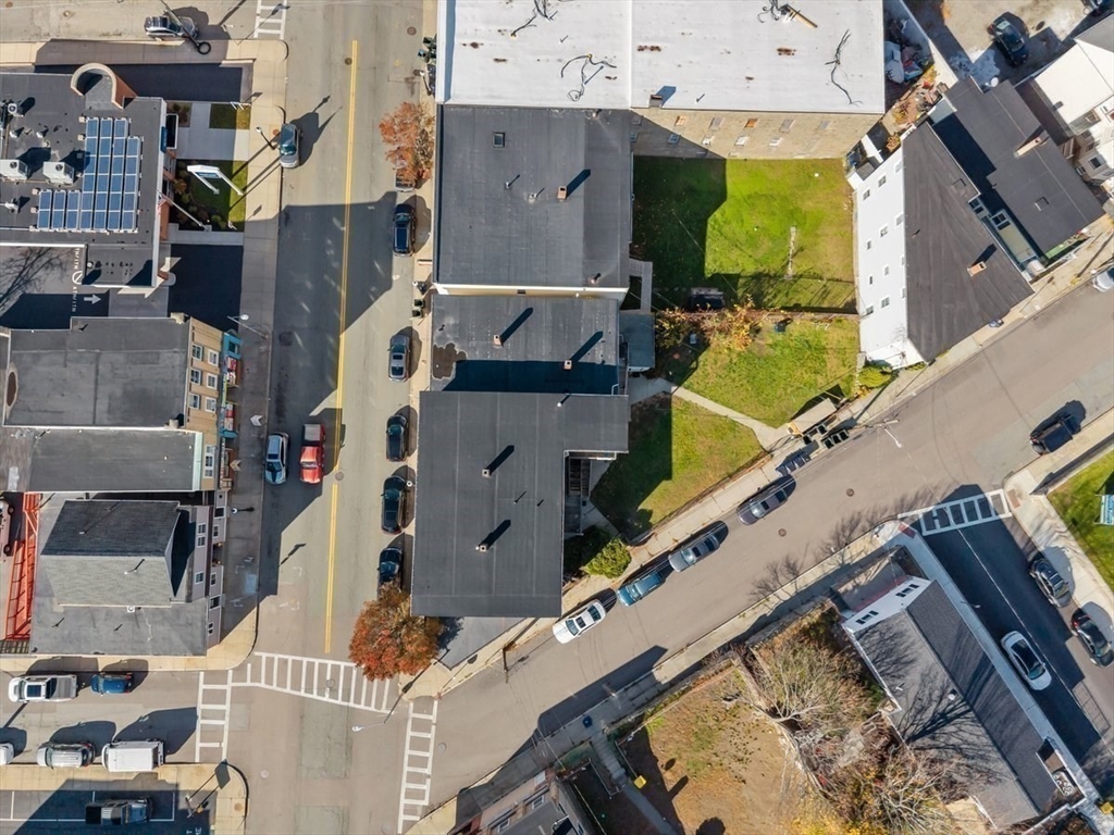1498-1508 Pleasant Street Fall River, MA 02723 - Photo 6 of 8 an aerial view of a residential apartment building with a yard