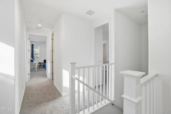 a view of a hallway with a livingroom and entryway