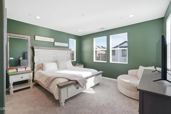 a bedroom with a bed and a couch