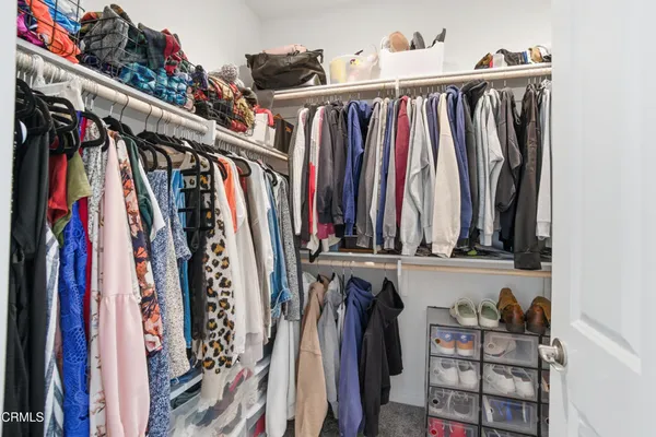 a view of walk in closet with clothes