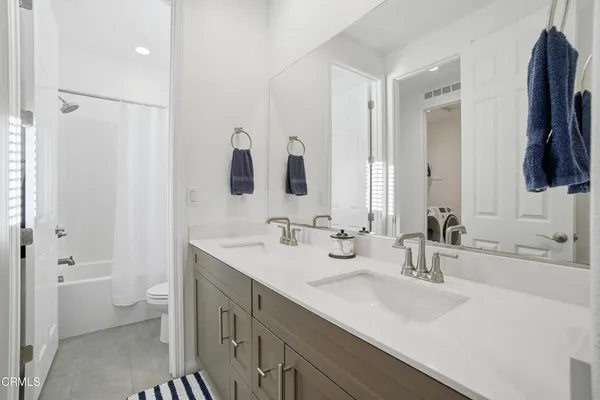 a bathroom with a double vanity sink and mirror
