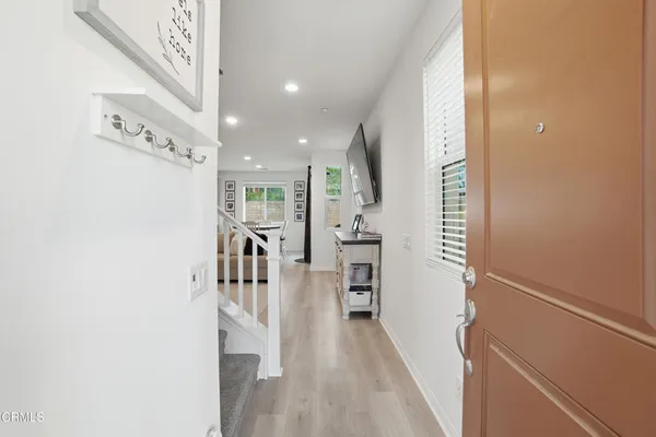 a view of a hallway with wooden floor and staircase