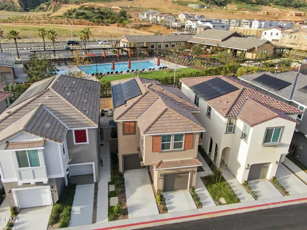 a aerial view of multiple houses with yard