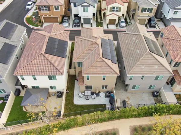 an aerial view of a house with a yard and potted plants