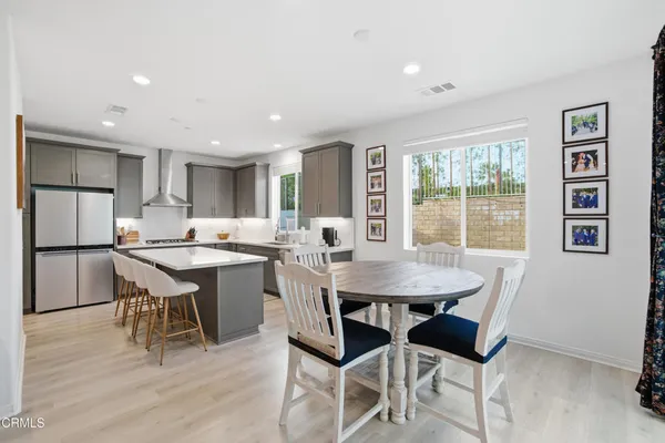 a dining room with a table chairs and a kitchen counter