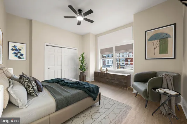 a spacious bedroom with a bed and a window