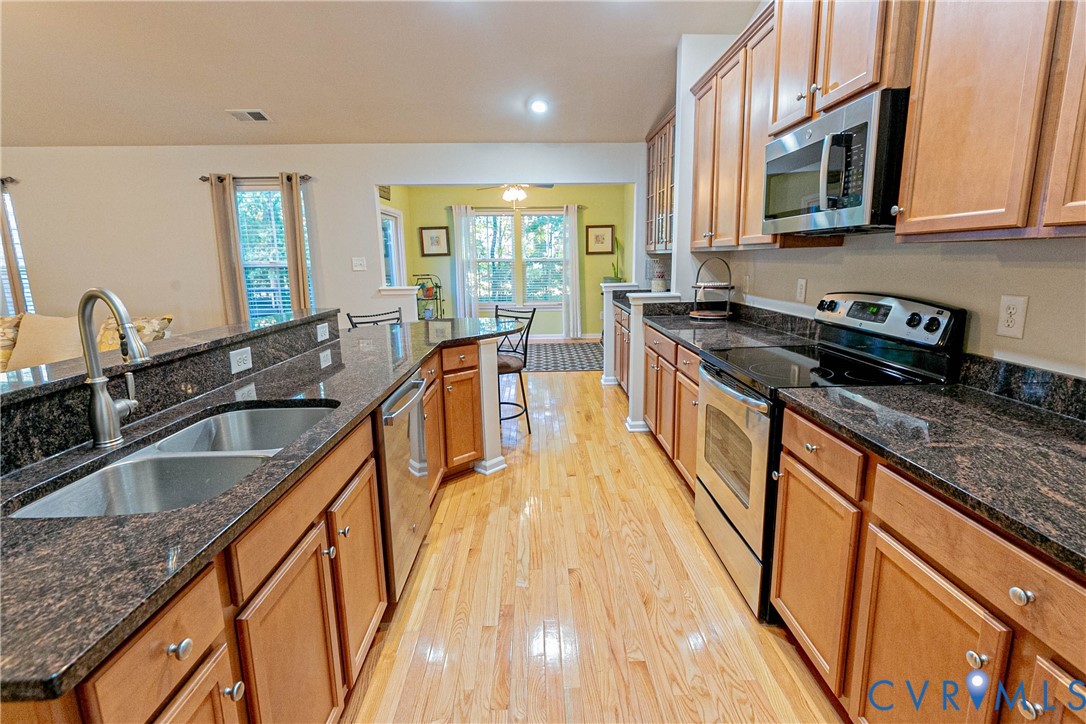 7533 South Franklins Way Quinton, VA 23141 - Photo 13 of 46 a kitchen with stainless steel appliances granite countertop a sink stove and refrigerator