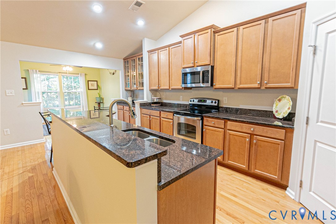 7533 South Franklins Way Quinton, VA 23141 - Photo 14 of 46 a kitchen with stainless steel appliances granite countertop a stove a sink a microwave and a refrigerator