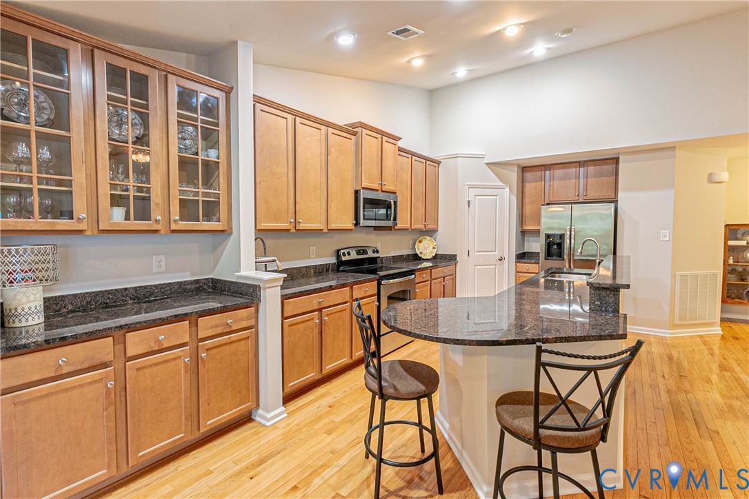 7533 South Franklins Way Quinton, VA 23141 - Photo 15 of 46 a kitchen with stainless steel appliances granite countertop a stove a sink and a granite counter tops