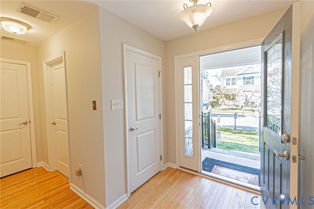 7533 South Franklins Way Quinton, VA 23141 - Photo 3 of 46 a view of a hallway with wooden floor and balcony with furniture