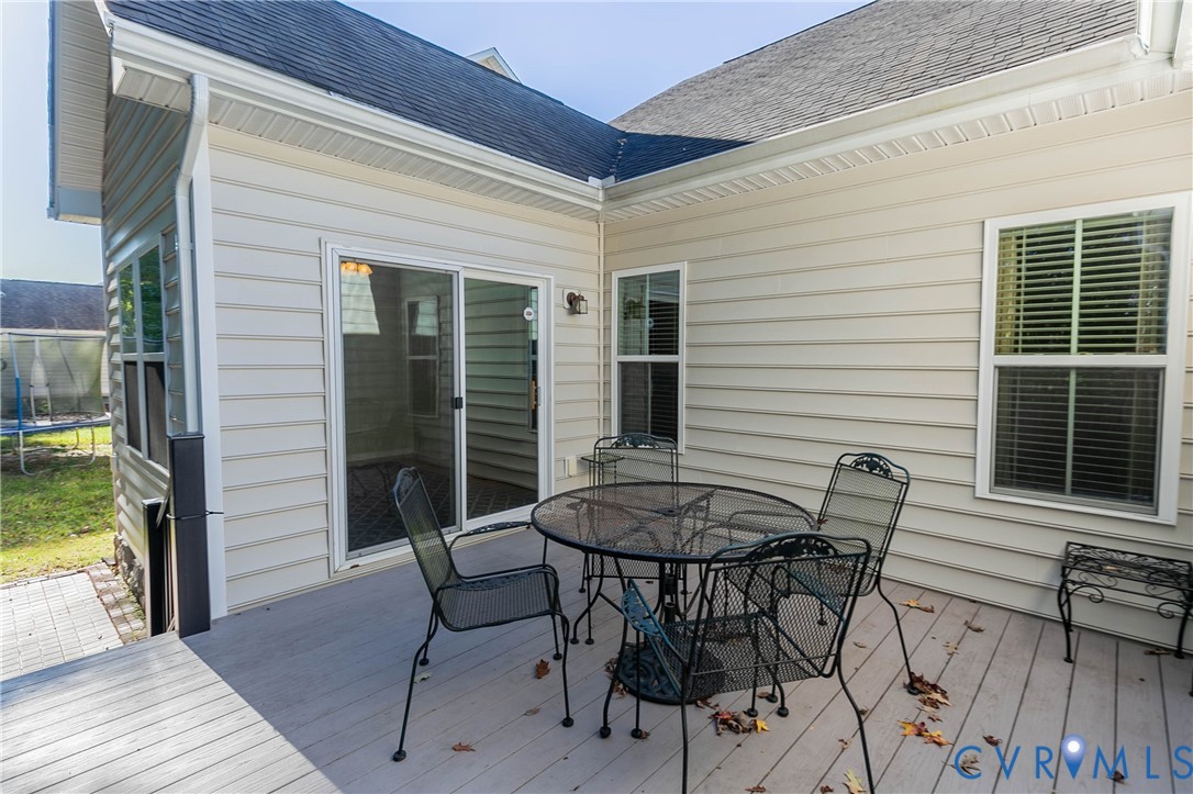 7533 South Franklins Way Quinton, VA 23141 - Photo 46 of 46 a view of a patio with table and chairs with wooden floor and fence