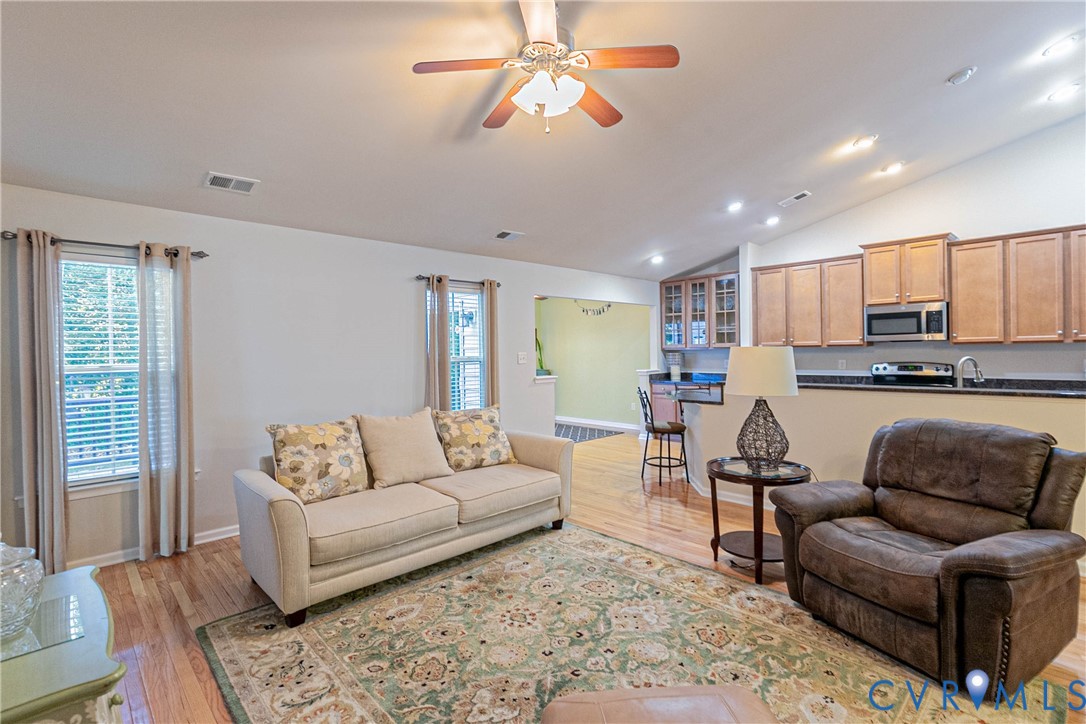 7533 South Franklins Way Quinton, VA 23141 - Photo 6 of 46 a living room with furniture and kitchen view