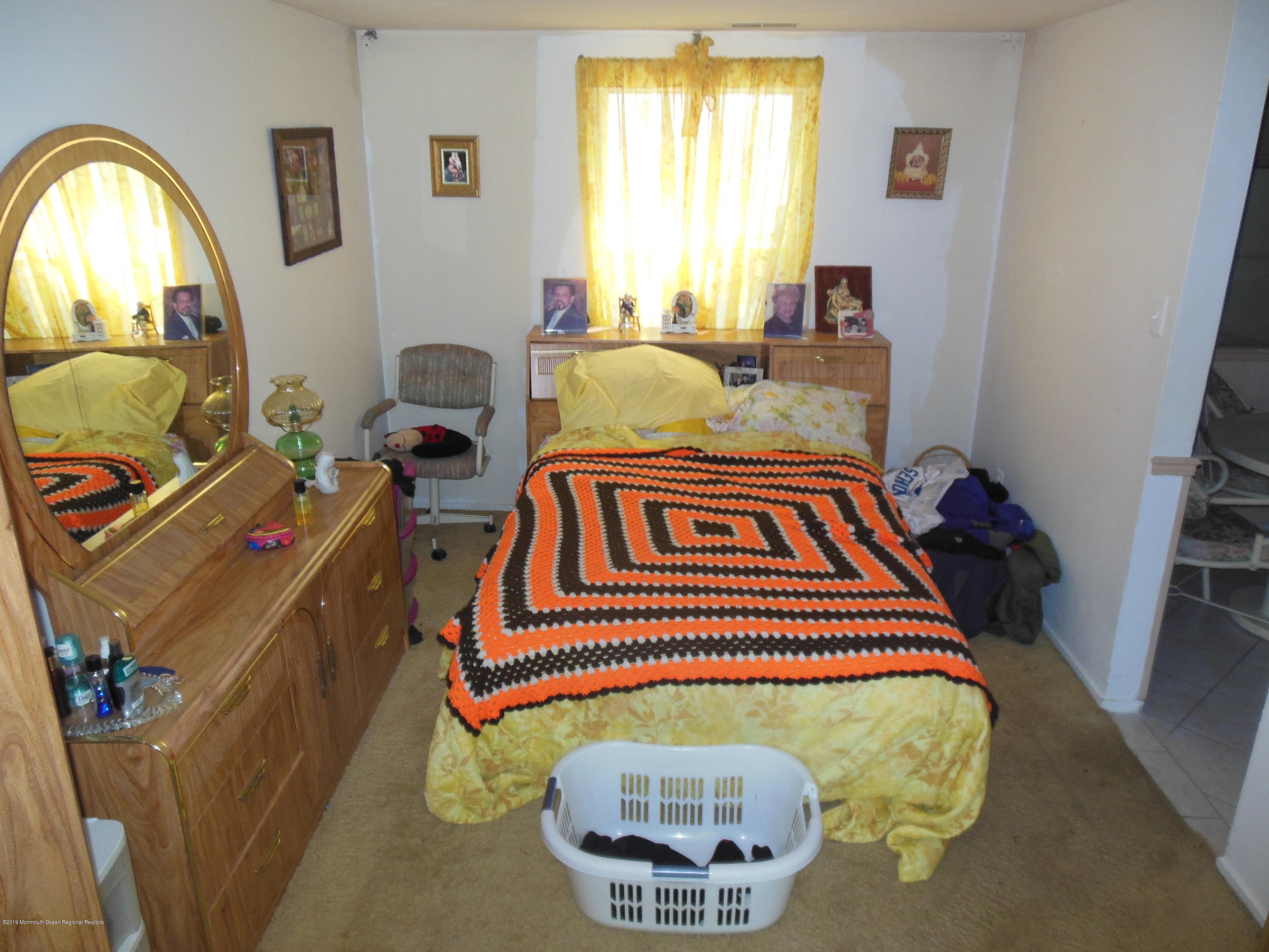 859 Radio Road Little Egg Harbor, NJ 08087 - Photo 3 of 17 a bedroom with a bed and a window