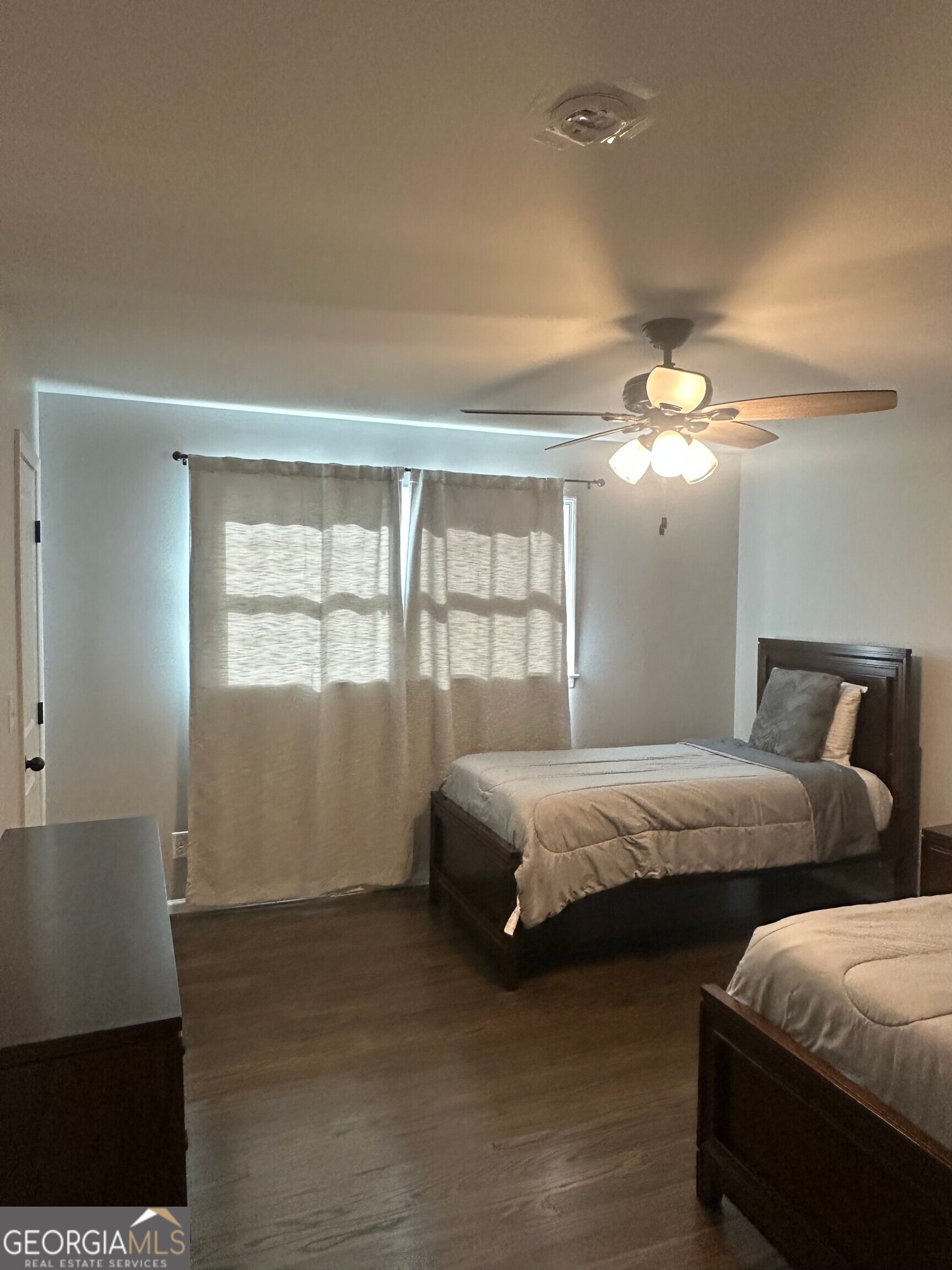 175 Thompson Place Gainesville, GA 30506 - Photo 11 of 32 a bedroom with two beds and a chandelier