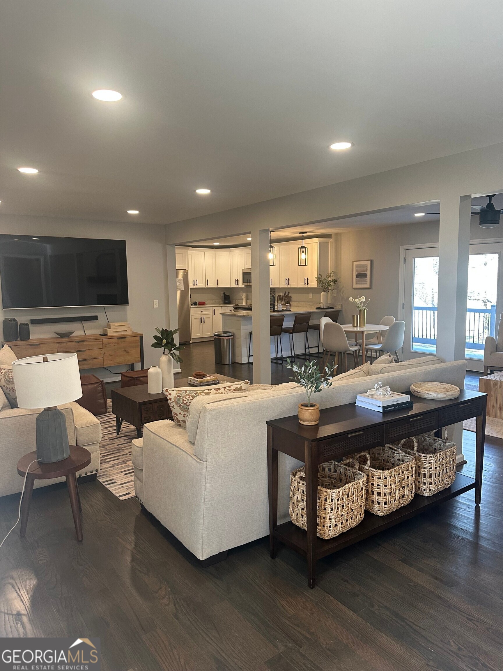 175 Thompson Place Gainesville, GA 30506 - Photo 12 of 32 a living room with furniture a flat screen tv and a large window
