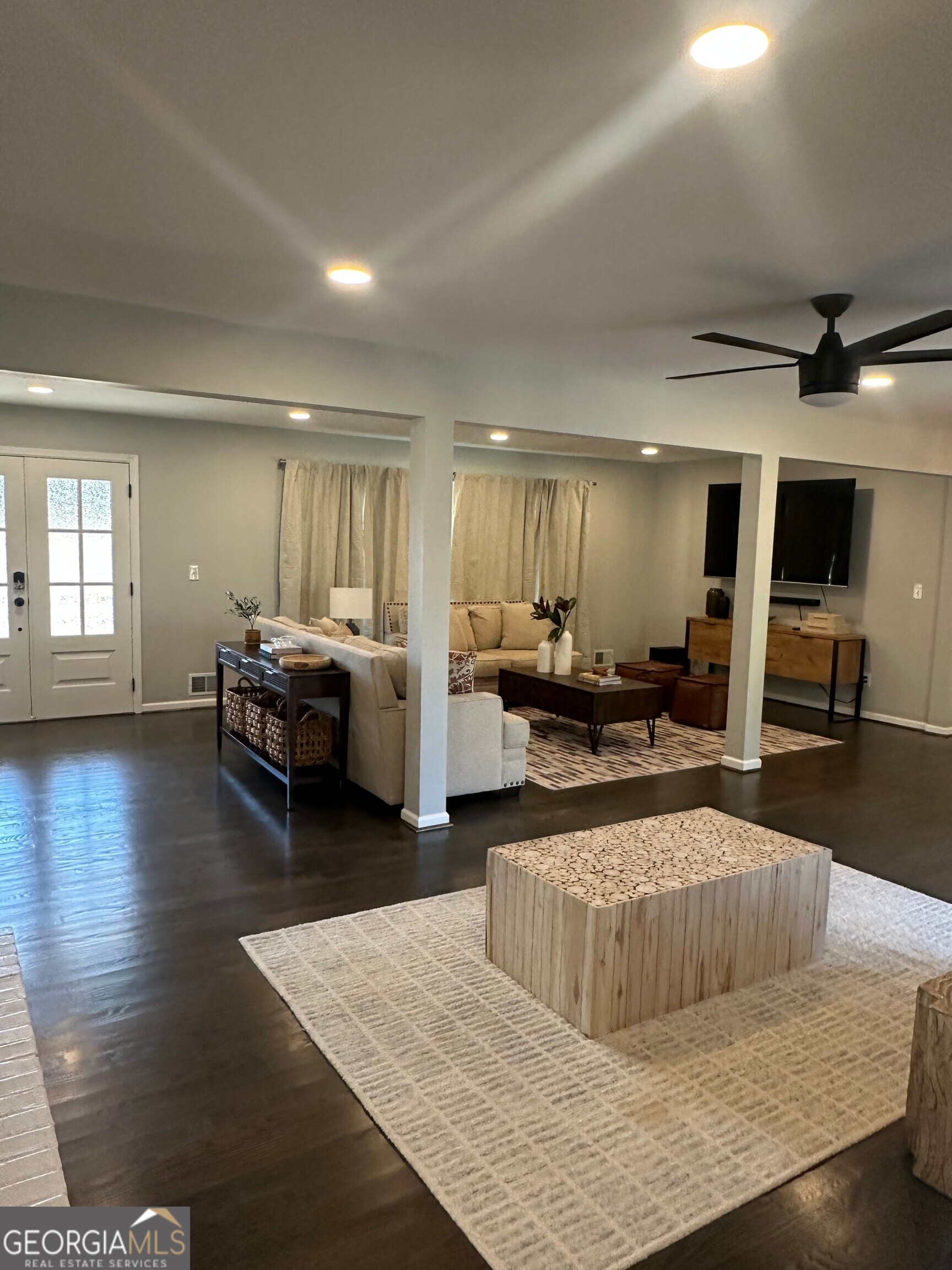 175 Thompson Place Gainesville, GA 30506 - Photo 19 of 32 a living room with furniture and a wooden floor