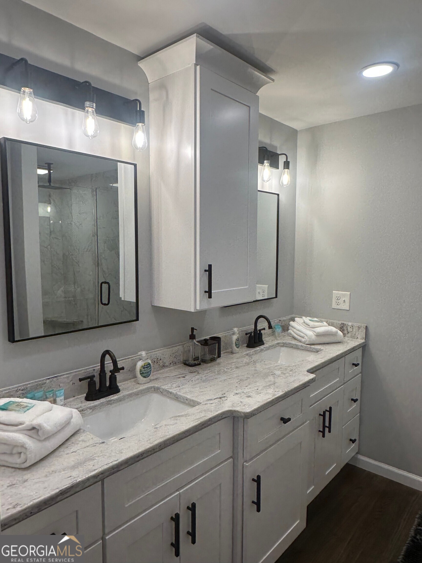 175 Thompson Place Gainesville, GA 30506 - Photo 21 of 32 a bathroom with double vanity sinks and a mirror