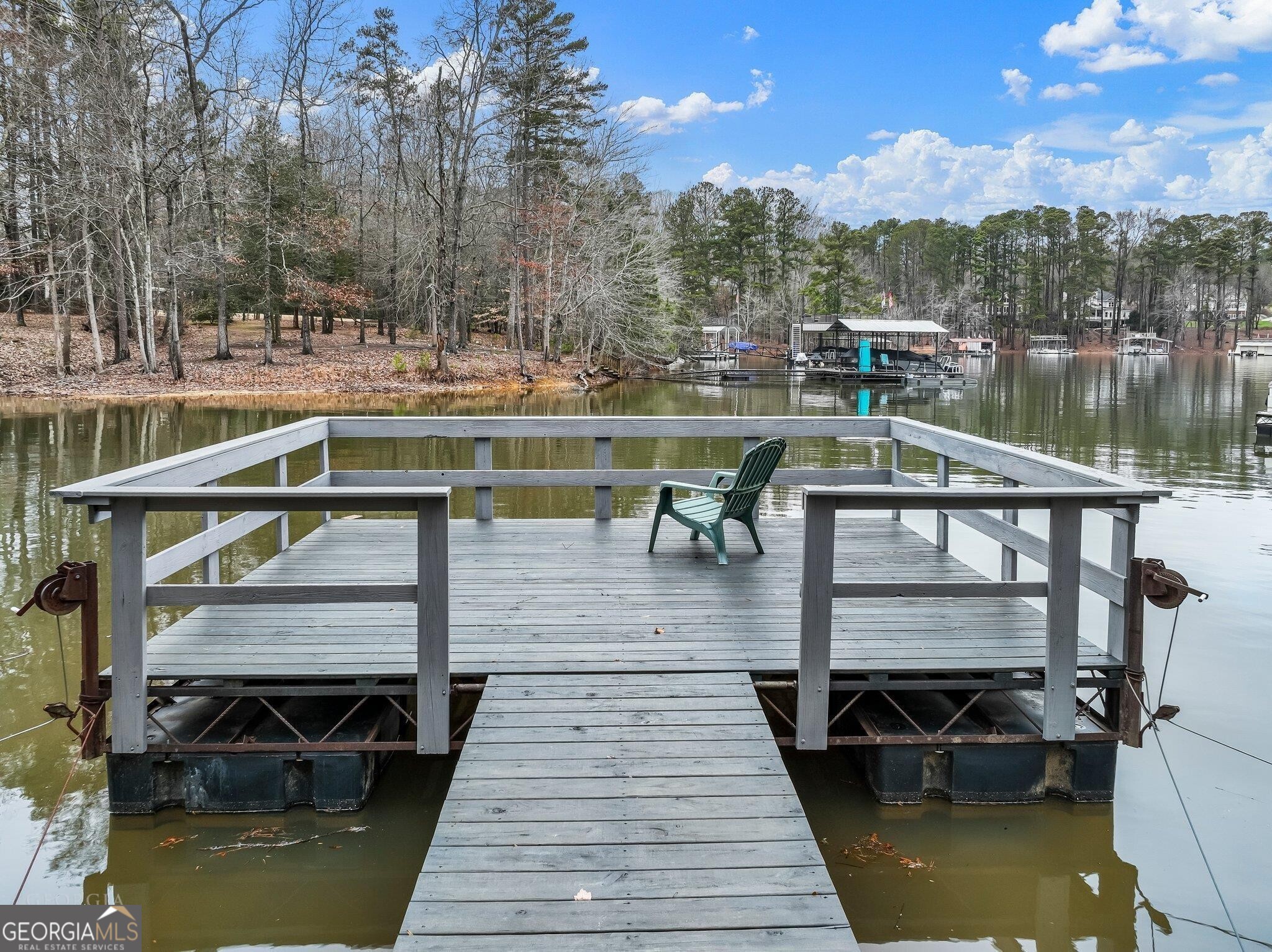 175 Thompson Place Gainesville, GA 30506 - Photo 23 of 32 a view of a wooden deck and lake