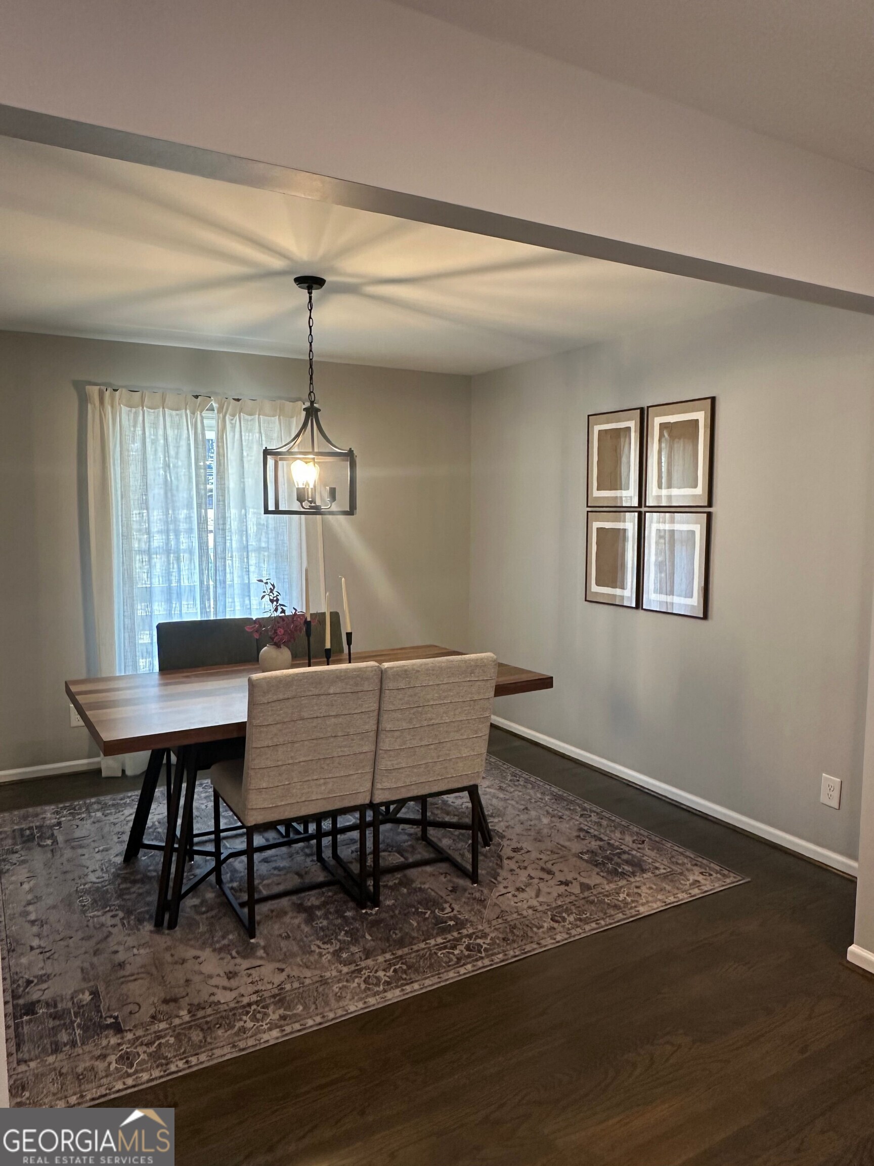 175 Thompson Place Gainesville, GA 30506 - Photo 3 of 32 a dining room with wooden floor a glass table and chairs