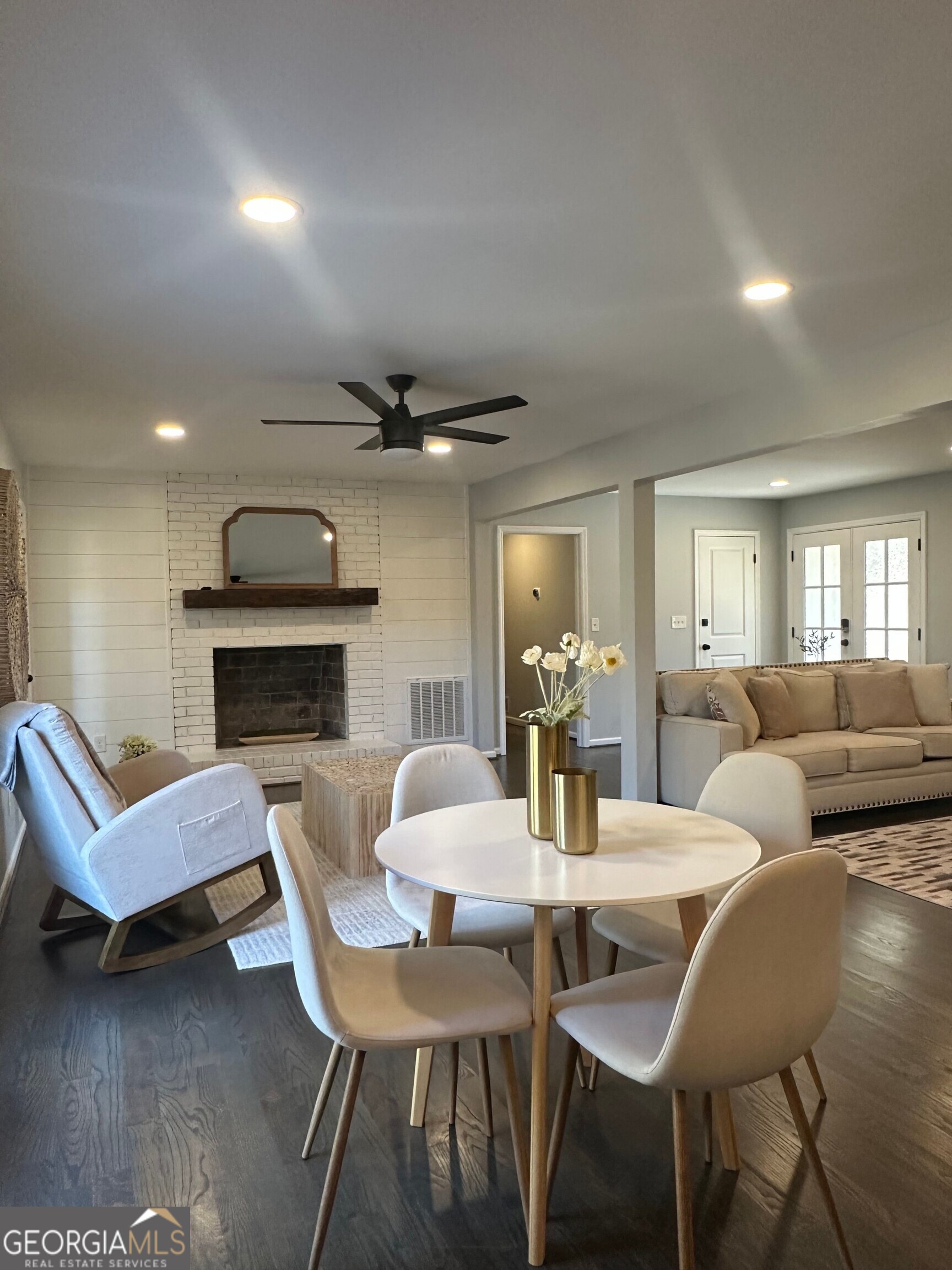 175 Thompson Place Gainesville, GA 30506 - Photo 4 of 32 a living room with furniture a fireplace and a table