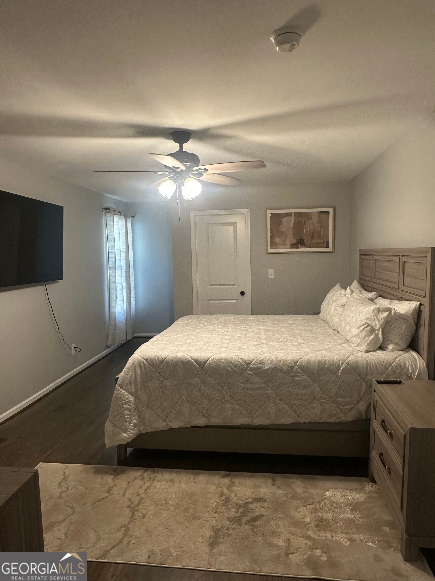 175 Thompson Place Gainesville, GA 30506 - Photo 10 of 32 a spacious bedroom with a bed and a flat screen tv