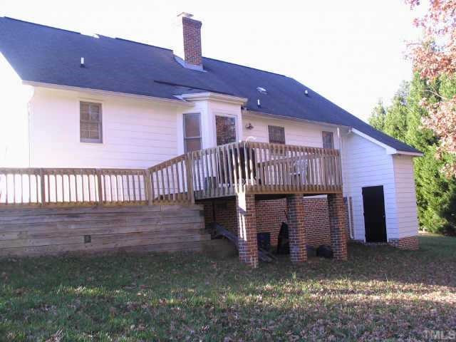 917 Fairlong Road Wake Forest, NC 27587 - Photo 2 of 12 Backyard view of home with large deck, walkway to parking and convenient storage area. Crawlspace access. Other