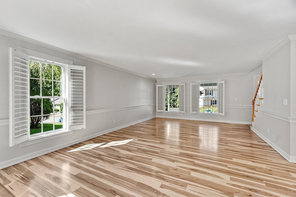 18 Sycamore Road Shrewsbury, MA 01545 - Photo 12 of 40 a view of empty room with wooden floor and fan