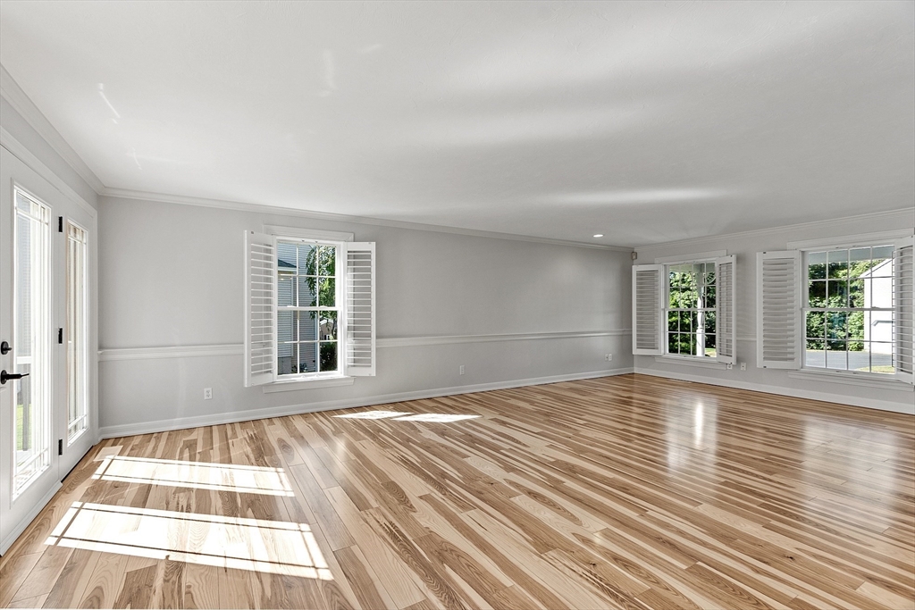 18 Sycamore Road Shrewsbury, MA 01545 - Photo 14 of 40 a view of an empty room with wooden floor and a window