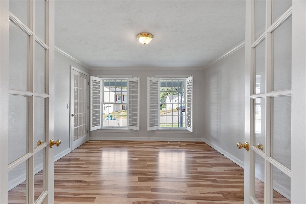 18 Sycamore Road Shrewsbury, MA 01545 - Photo 15 of 40 a view of empty room with wooden floor and fan