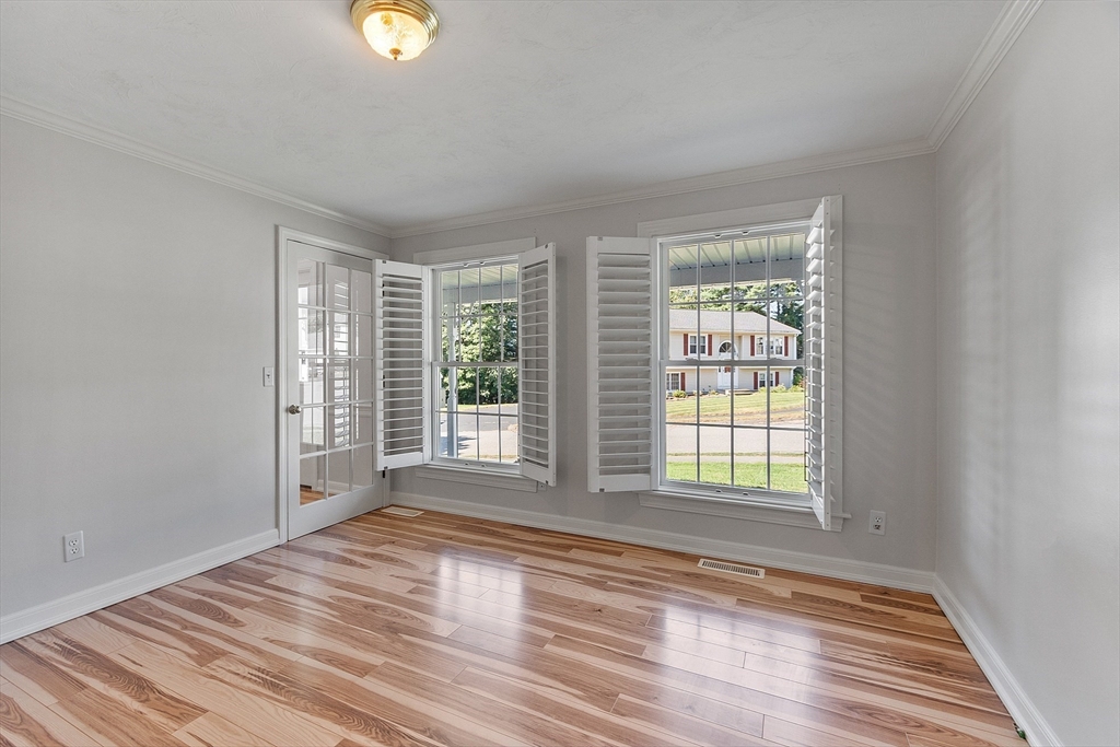 18 Sycamore Road Shrewsbury, MA 01545 - Photo 16 of 40 a view of an empty room with wooden floor and a window