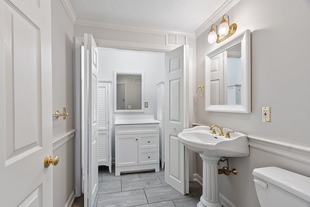 18 Sycamore Road Shrewsbury, MA 01545 - Photo 31 of 40 a bathroom with a sink mirror toilet and vanity