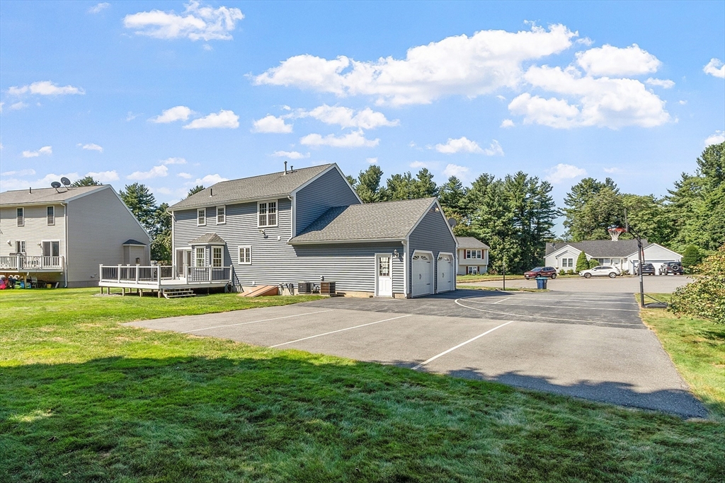 18 Sycamore Road Shrewsbury, MA 01545 - Photo 34 of 40 a front view of a house with a yard and garage