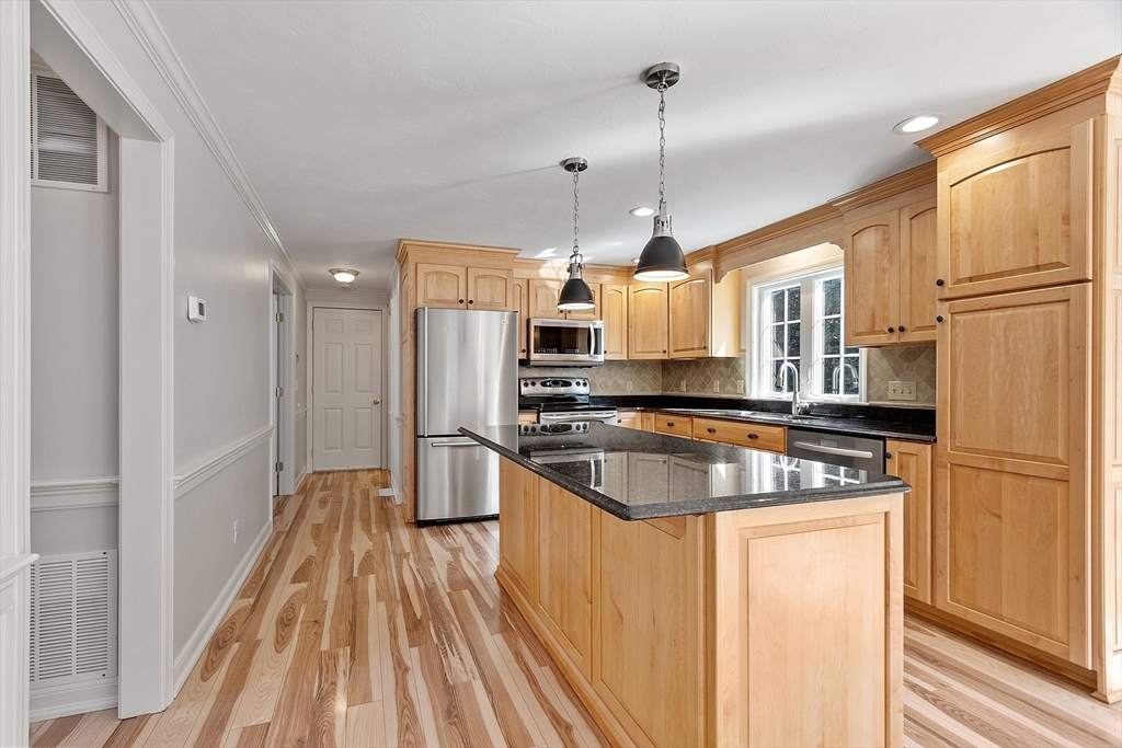 18 Sycamore Road Shrewsbury, MA 01545 - Photo 5 of 40 a kitchen with stainless steel appliances granite countertop a refrigerator a stove and a sink