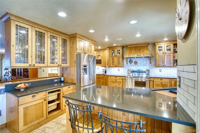 a kitchen with stainless steel appliances granite countertop a sink and cabinets