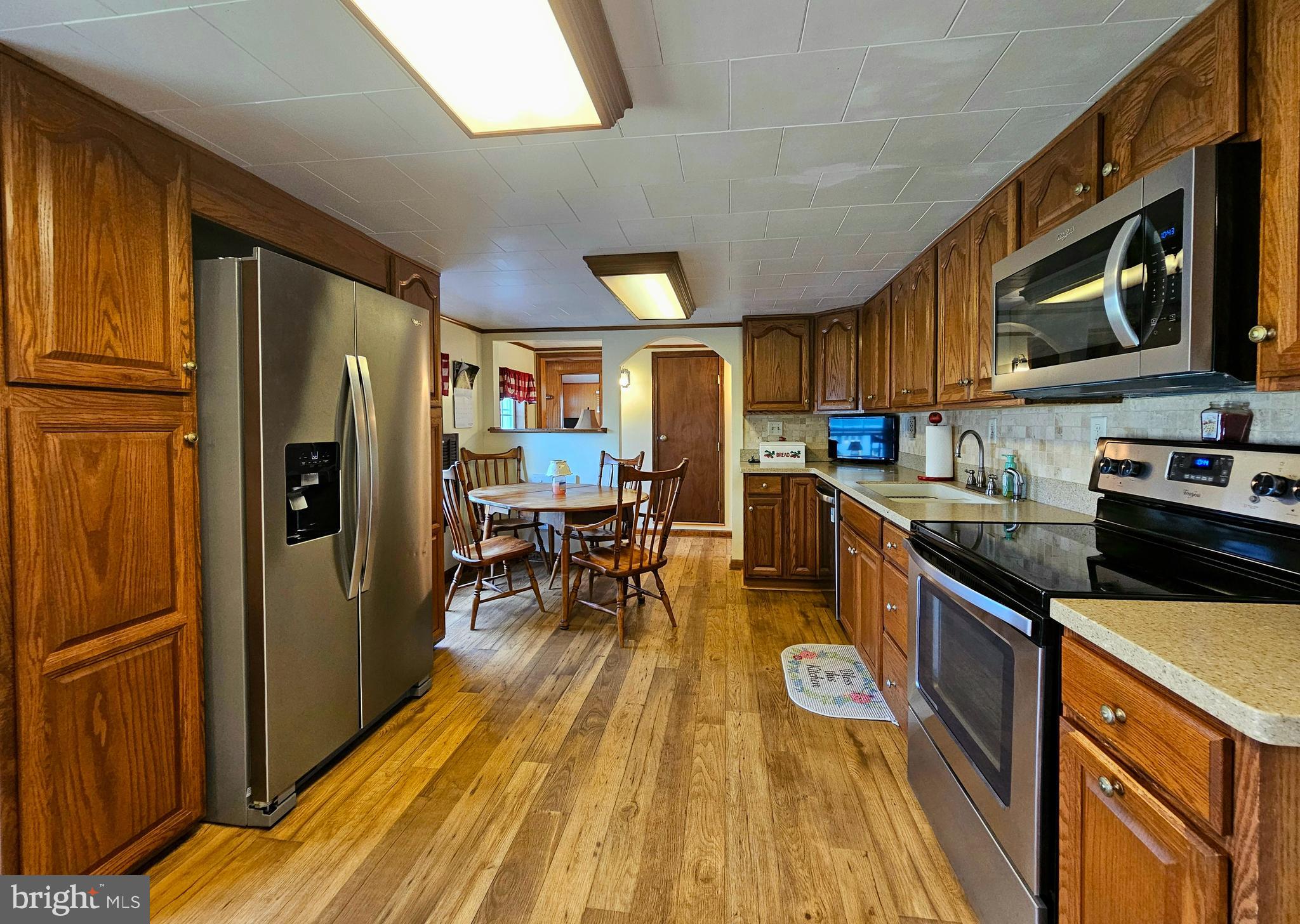 7558 Catlin Road Westover, MD 21871 - Photo 12 of 40 a kitchen with stainless steel appliances granite countertop a refrigerator a stove top oven a sink and dishwasher