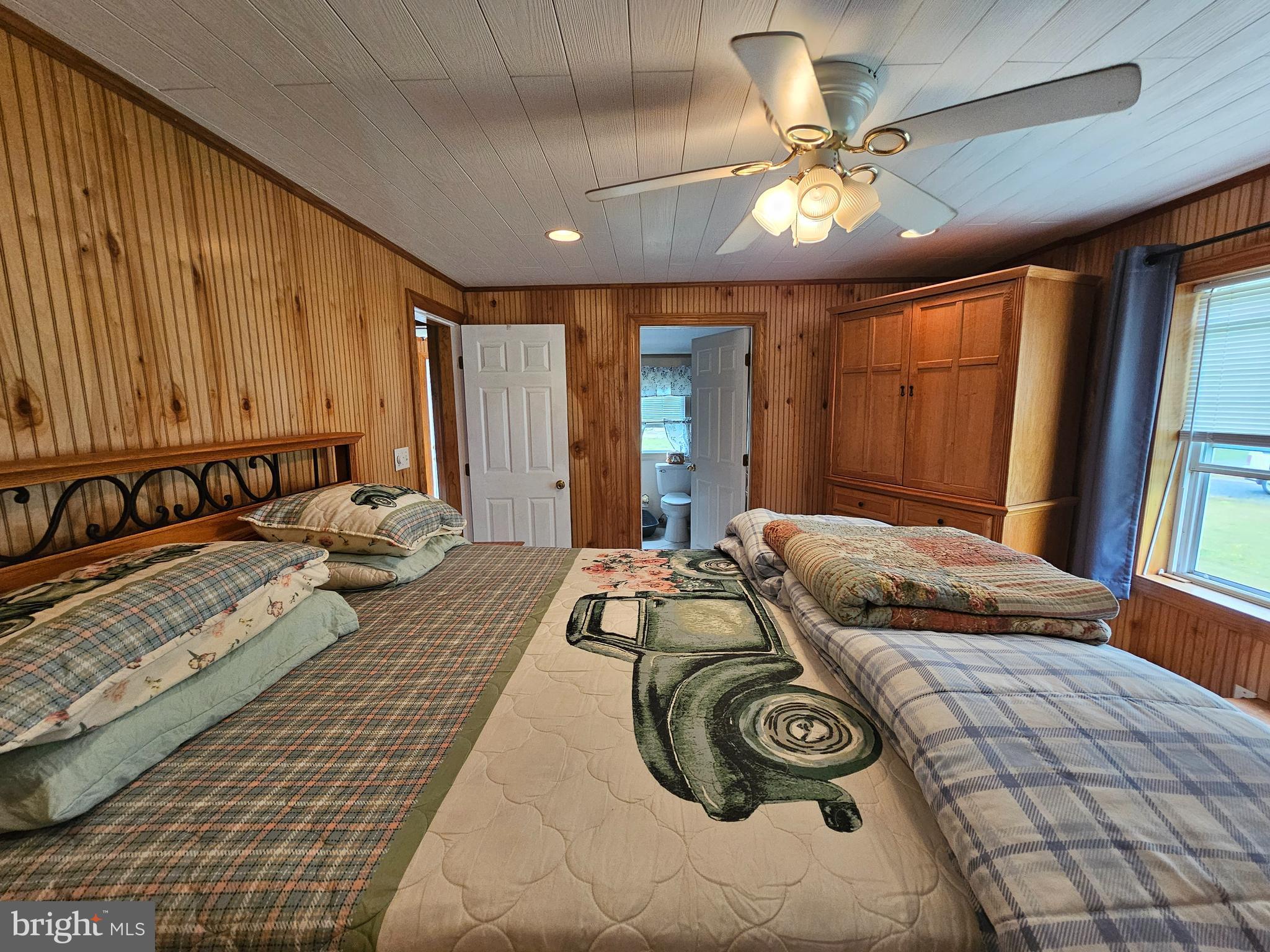 7558 Catlin Road Westover, MD 21871 - Photo 19 of 40 a bedroom with a large bed and a chandelier