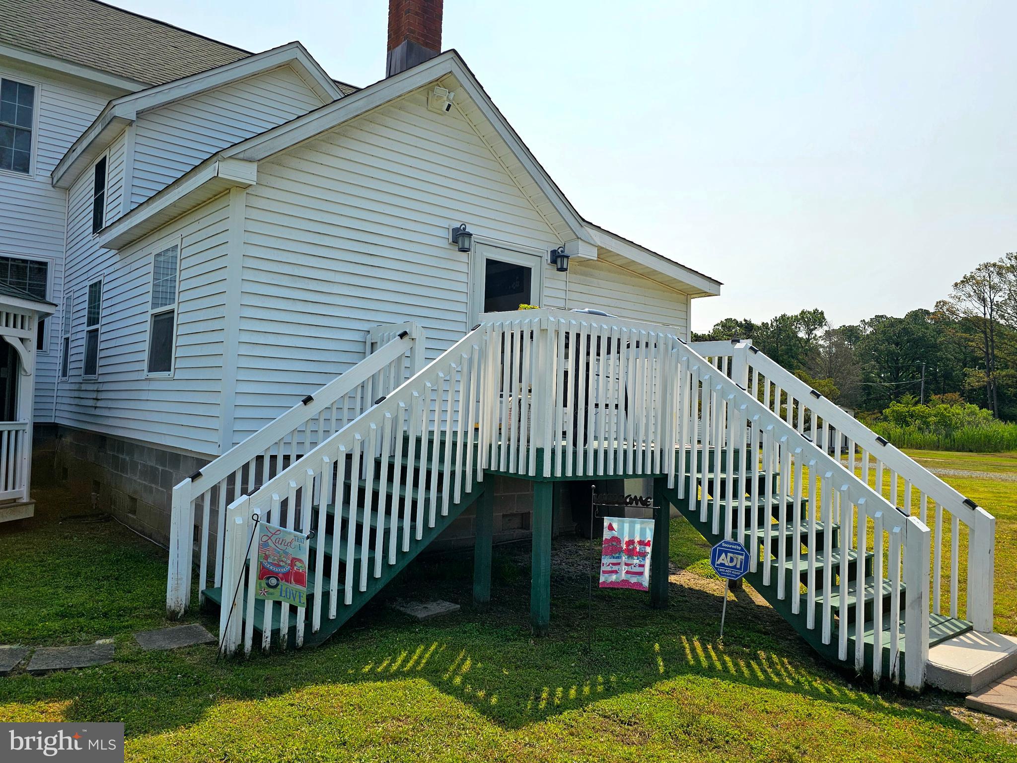 7558 Catlin Road Westover, MD 21871 - Photo 33 of 40 a view of a house with a wooden deck stairs and a yard