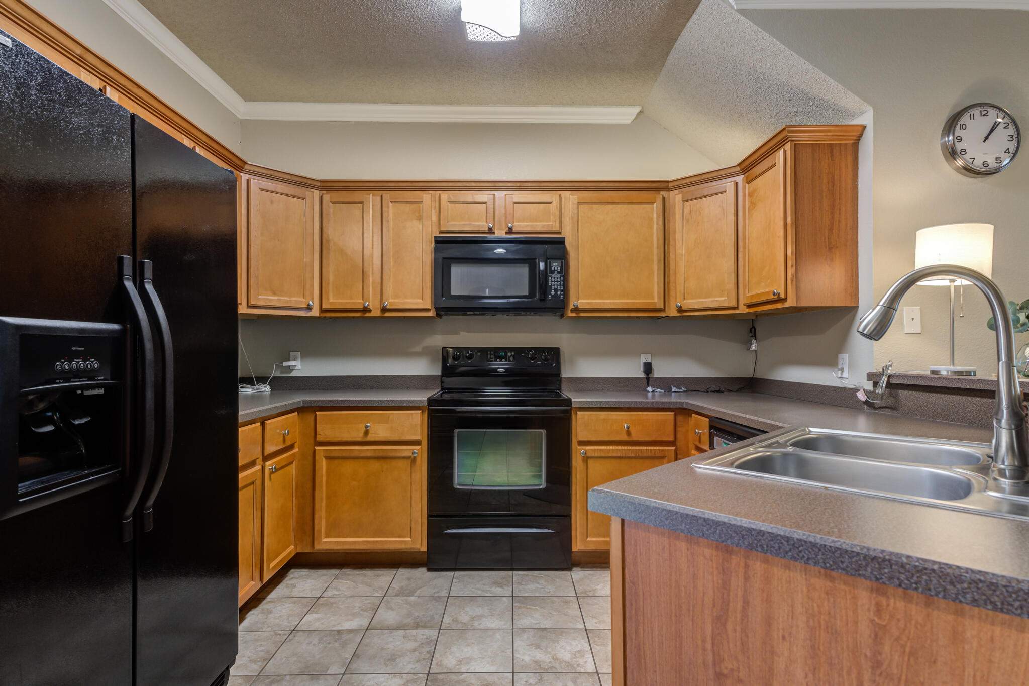 2108 Main Street, Unit 1 Lubbock, TX 79401 - Photo 11 of 29 a kitchen with stainless steel appliances granite countertop a stove refrigerator and a sink